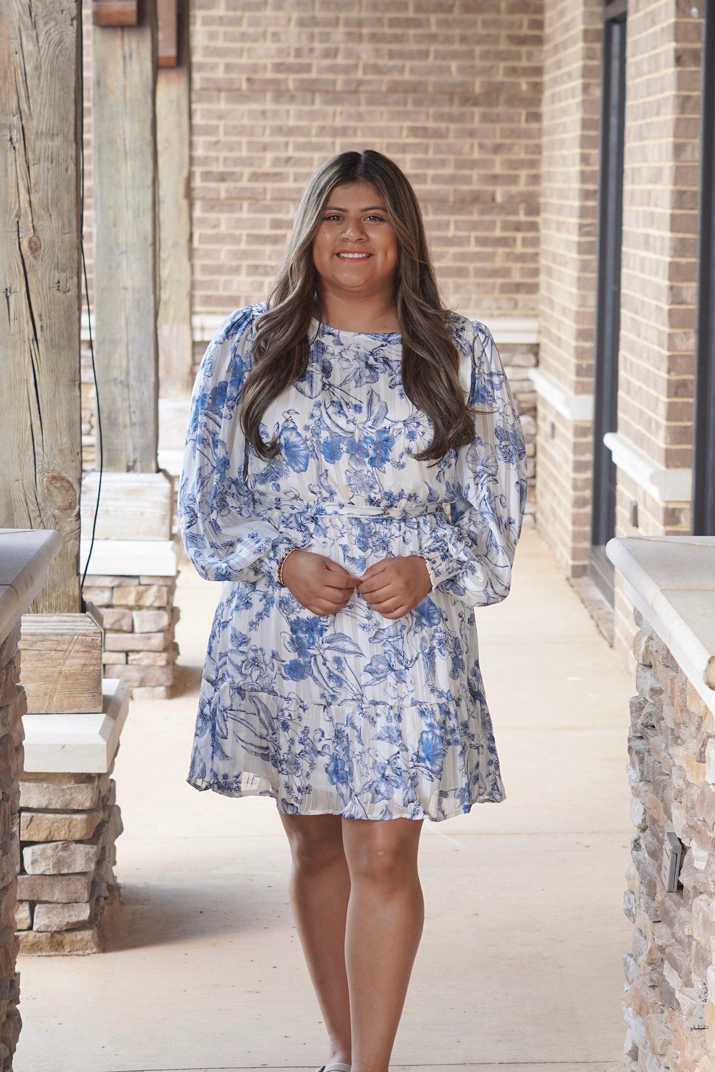 Women wearing a  Blue Long Sleeve Dress, Round Neckline, Cinched Waistline, Removable Belt, Glitter Detail, Floral print, Flowy.