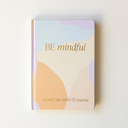 "Be Mindful" Journal. Size: 8.25" x 5.75". Prompted Journal. Design: Be Mindful: A Daily Five Minute Journal. Pastel Colored Journal with Gold Foil Details. 100gsm Uncoated Lined Paper.  Ribbon Bookmark in Gold. 184 Pages Front and Back