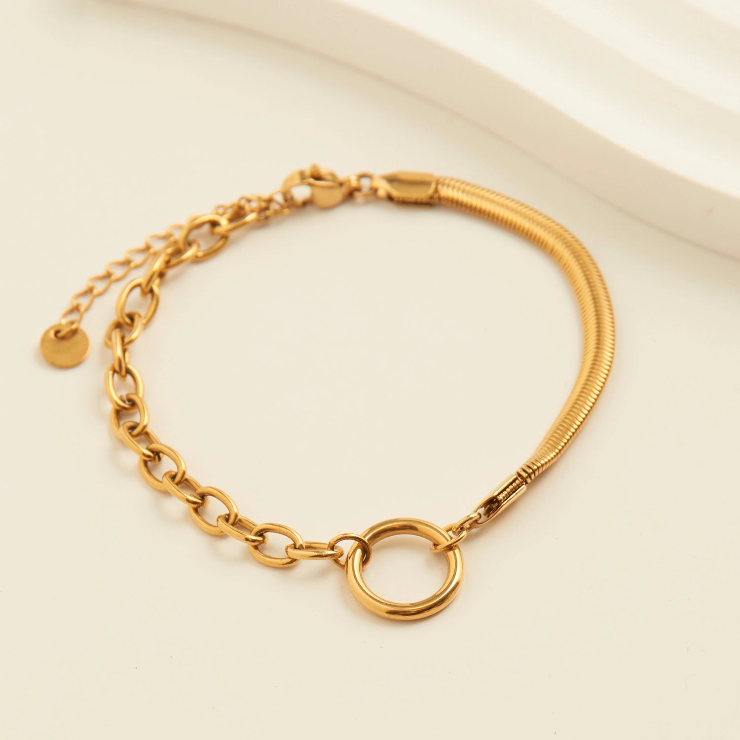 Gold Cable and Snake Chain Bracelet with a circle detail connecting them, lobster clasp. 