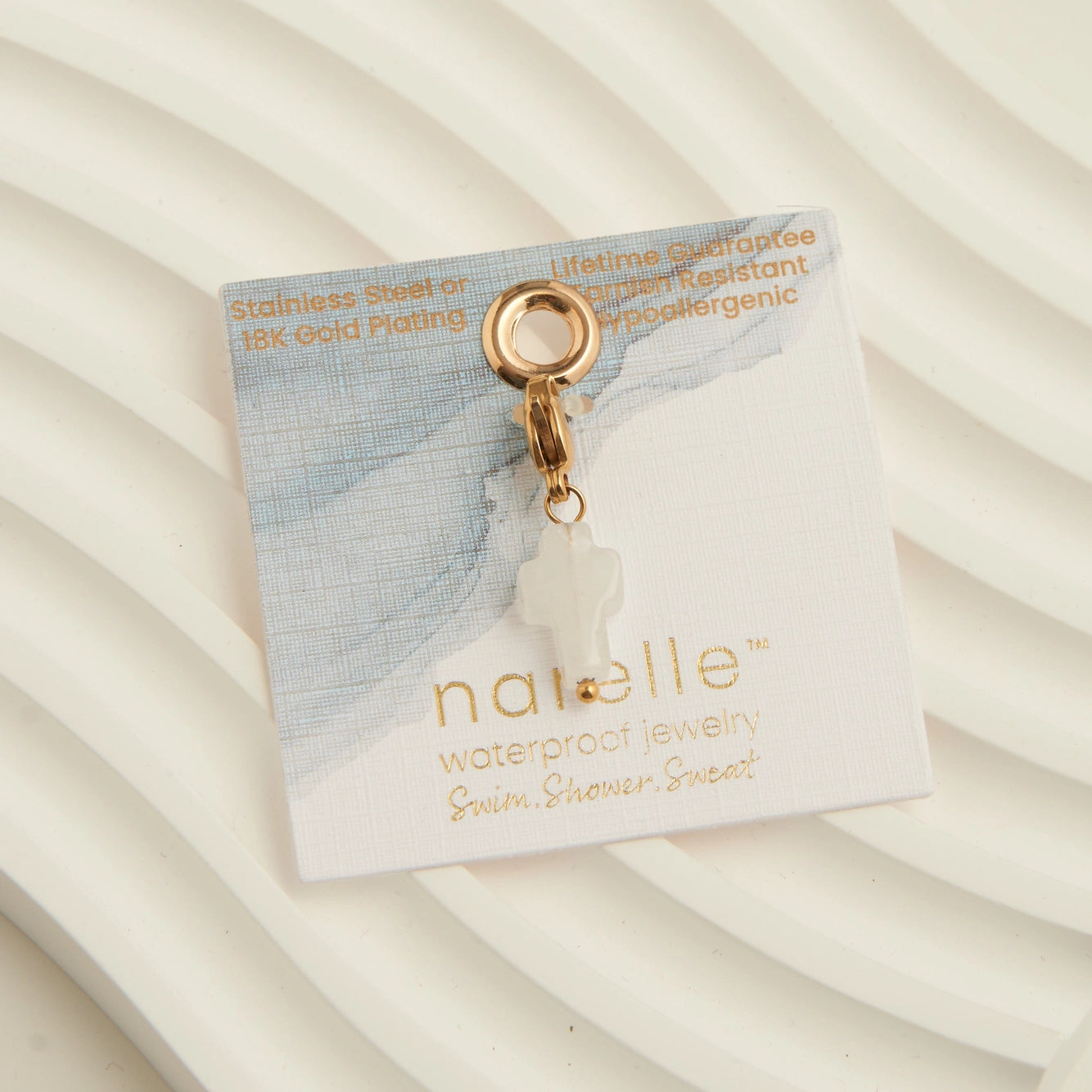 Pearl white cross charm with a gold claps 