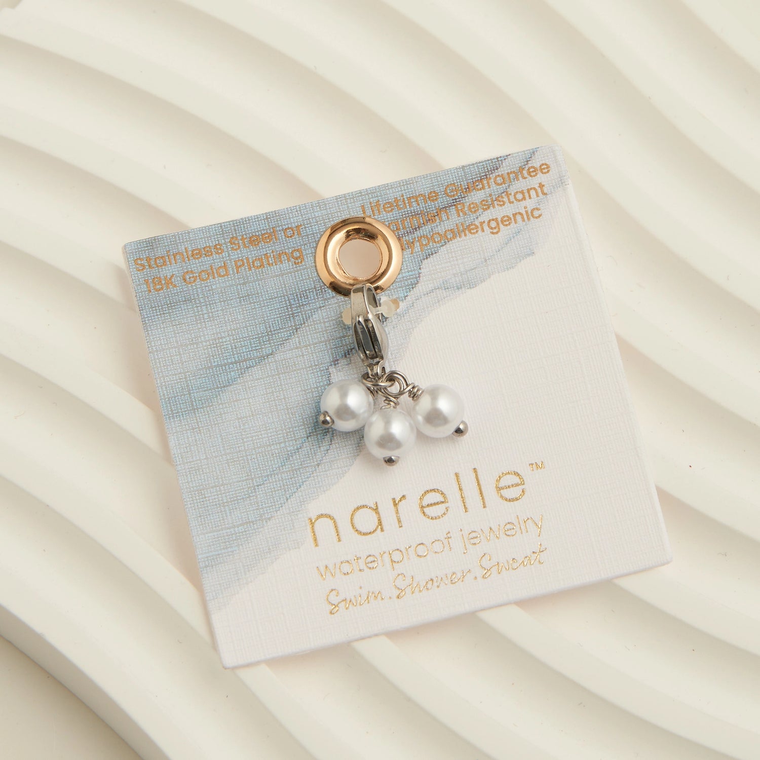 three pearl charms with a sliver lobster clasp. 