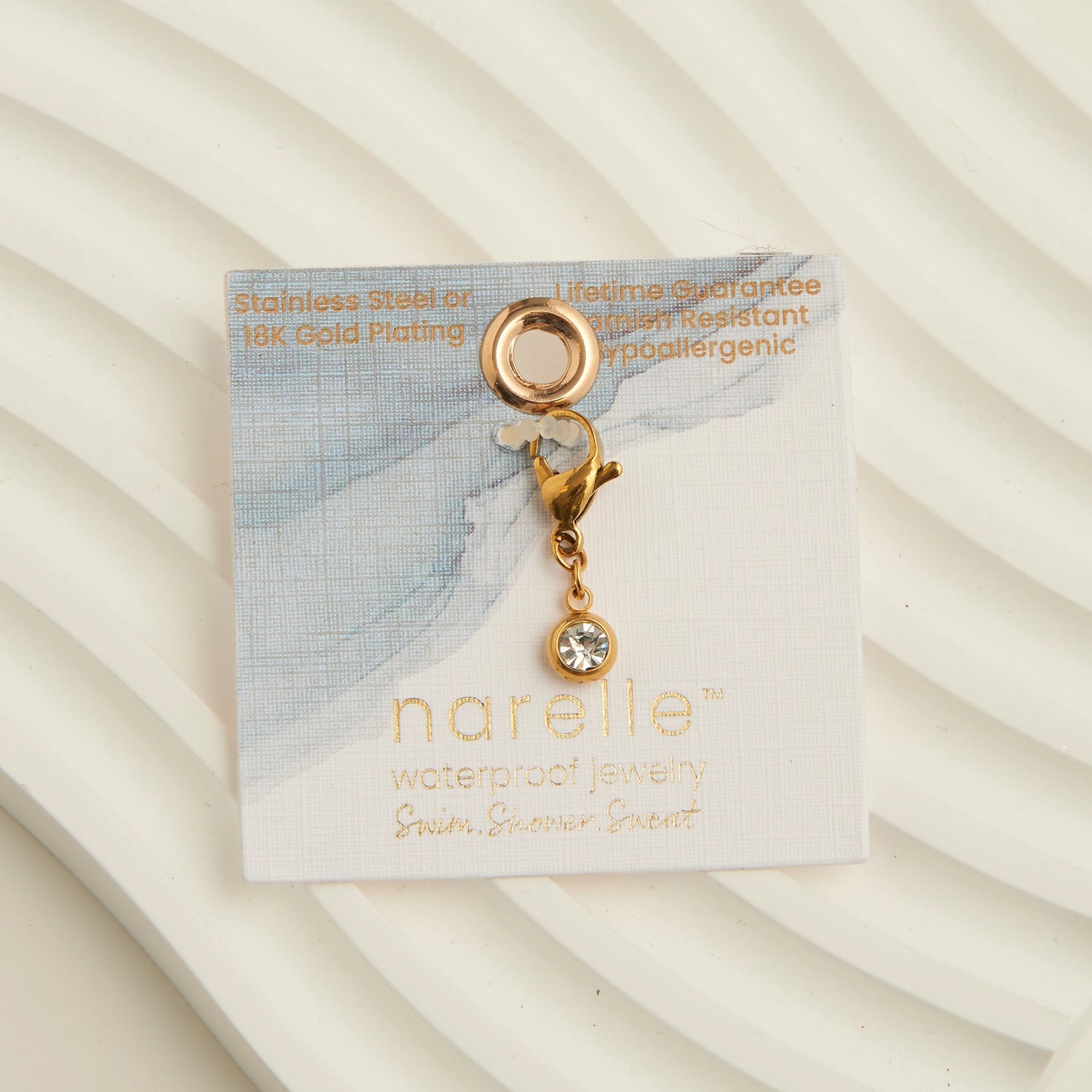 cubic zirconia circle charm with a gold lobster claps 