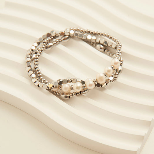 Genuine Pearl Ball Bracelet. This 3-piece stretch-fit stack features polished ball beads accented with luminous genuine pearls, offering a refined mix of texture and shine