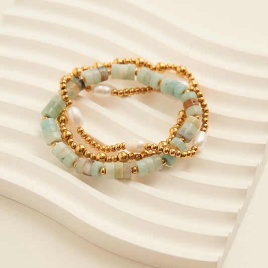 Mixed Bead Pearl Bracelet Set. This 3-piece stack features a stunning blend of smooth gold ball beads, luminous freshwater pearls, and soft-toned genuine stone accents.