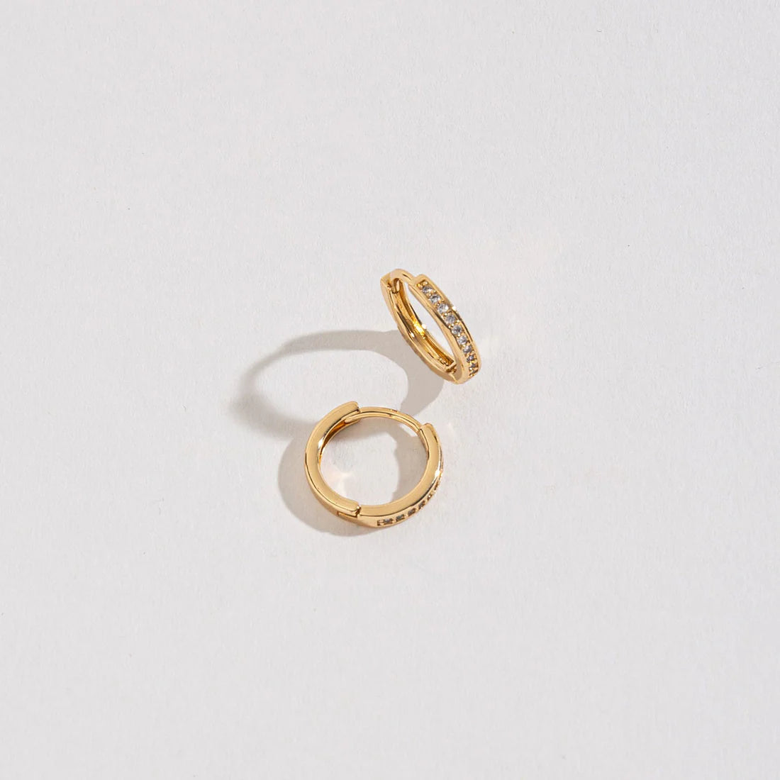 Gold Hoop earrings, each with small spaced diamonds. 