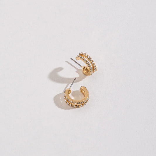 gold double pave style hoop earrings with embedded stones. 