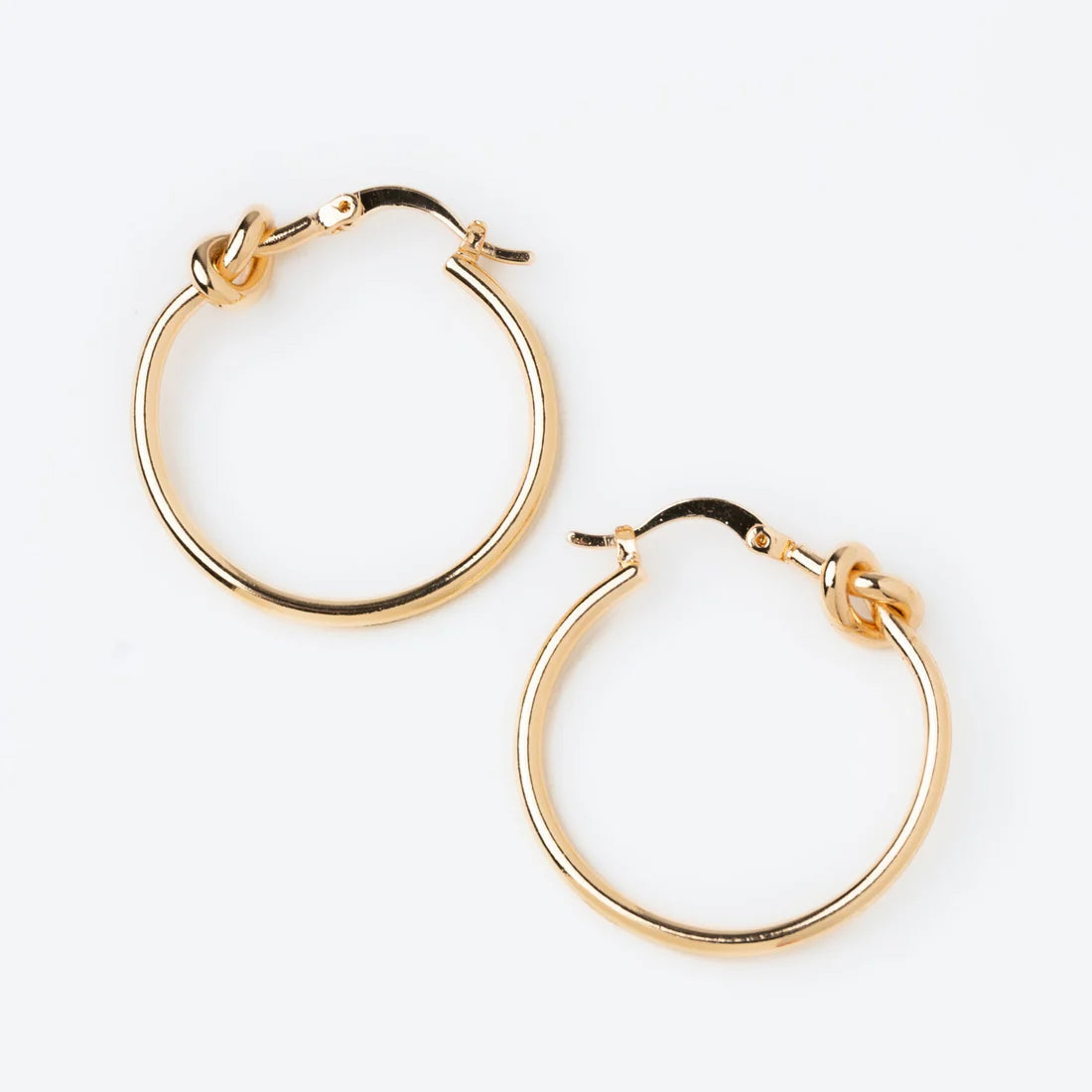 The Medium Knotted Hoop Earrings feature a timeless hoop design in elegant gold