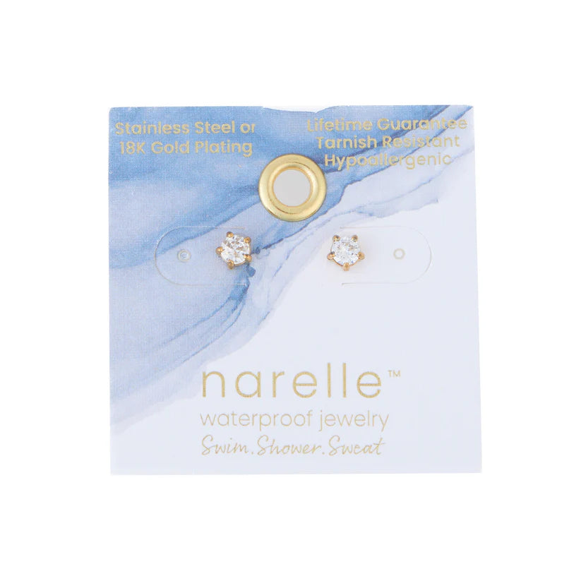 A paired of stud earrings feature a central, gemstone surrounded by a gold. 