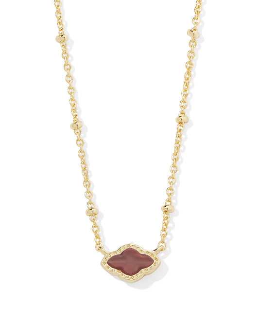 Gold necklace with abbie pendant. Stone in the pendant is cranberry illusion (dark red). Lobster clasp closure with adjustable slider bead. 