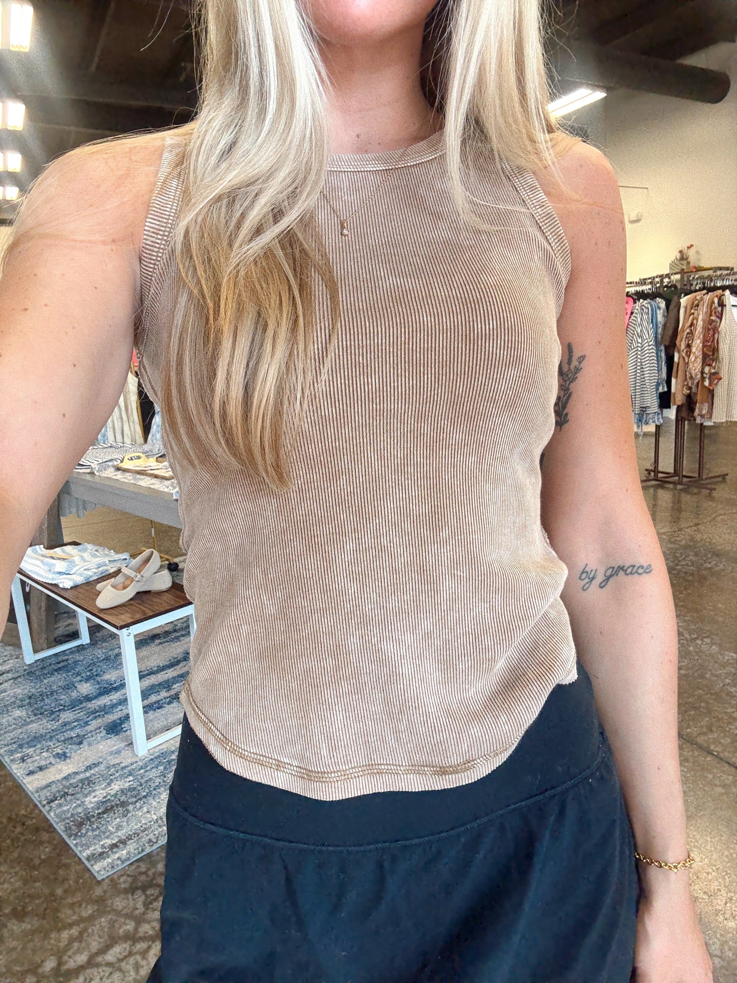Women wearing a ribbed brown tank, fitted style and a round neckline.  