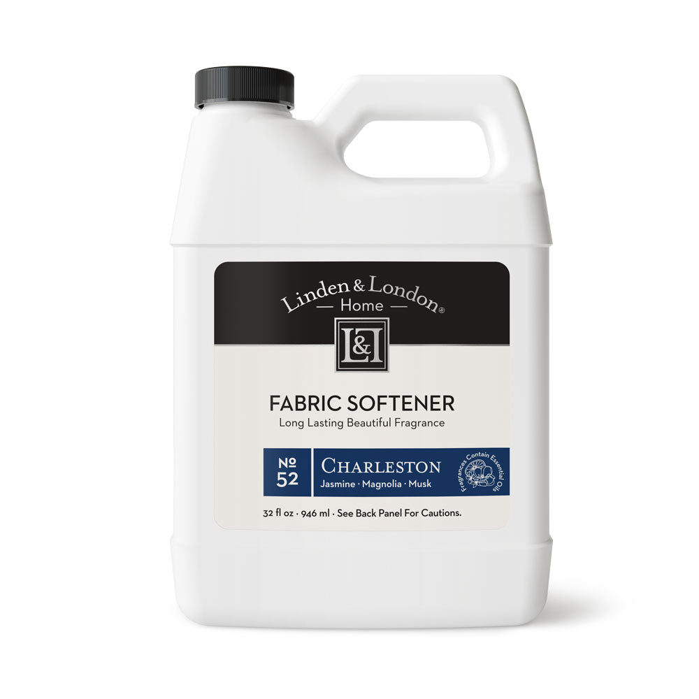 Jasmine, magnolia, and musk scented fabric softener a white bottle with a handle 