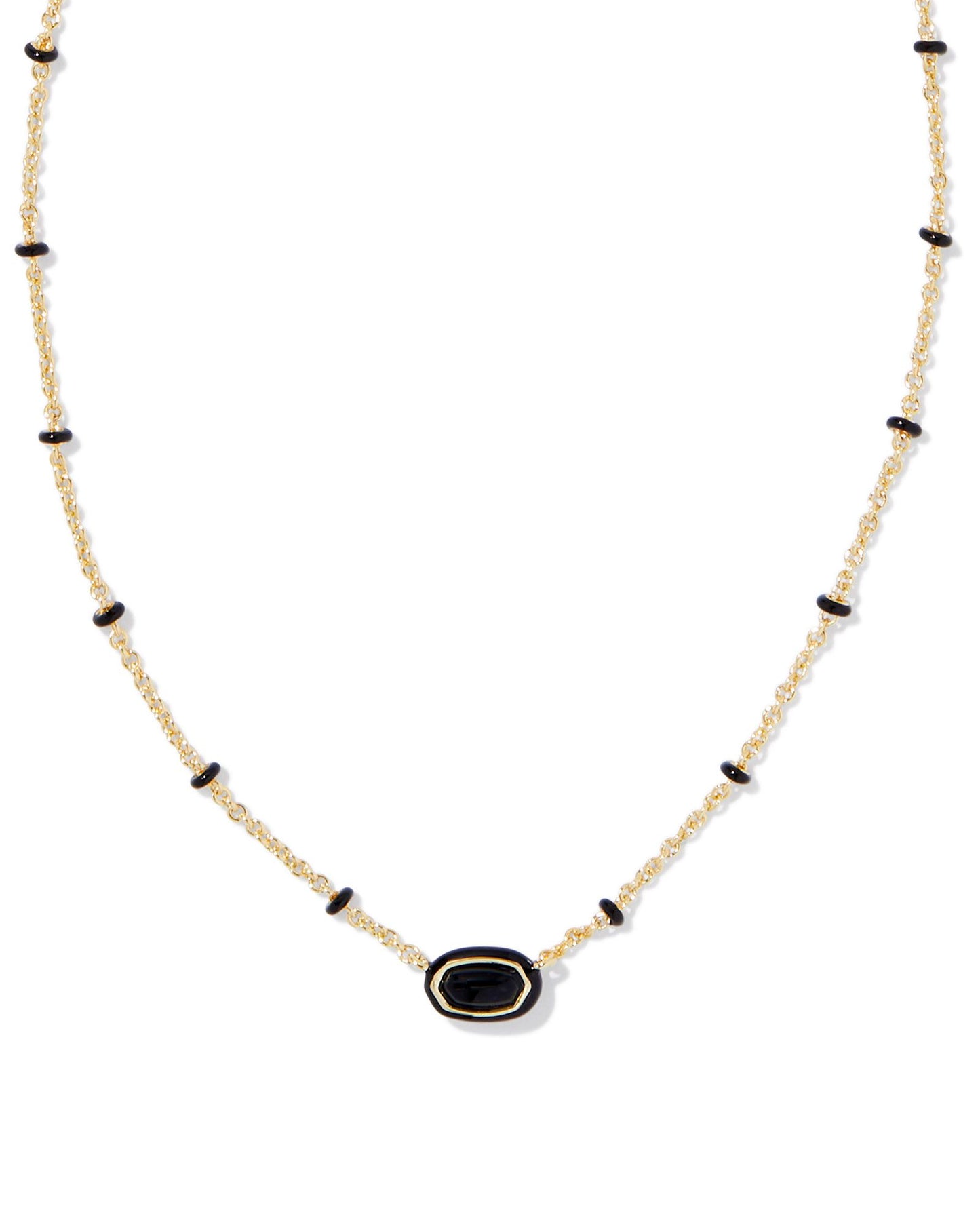 gold necklace with black enamel detailing and a small black stoned pendant