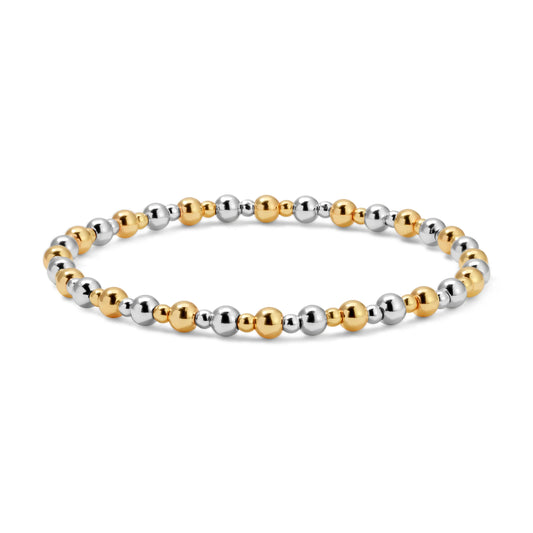 Bracelet with gold and silver beads on a white background