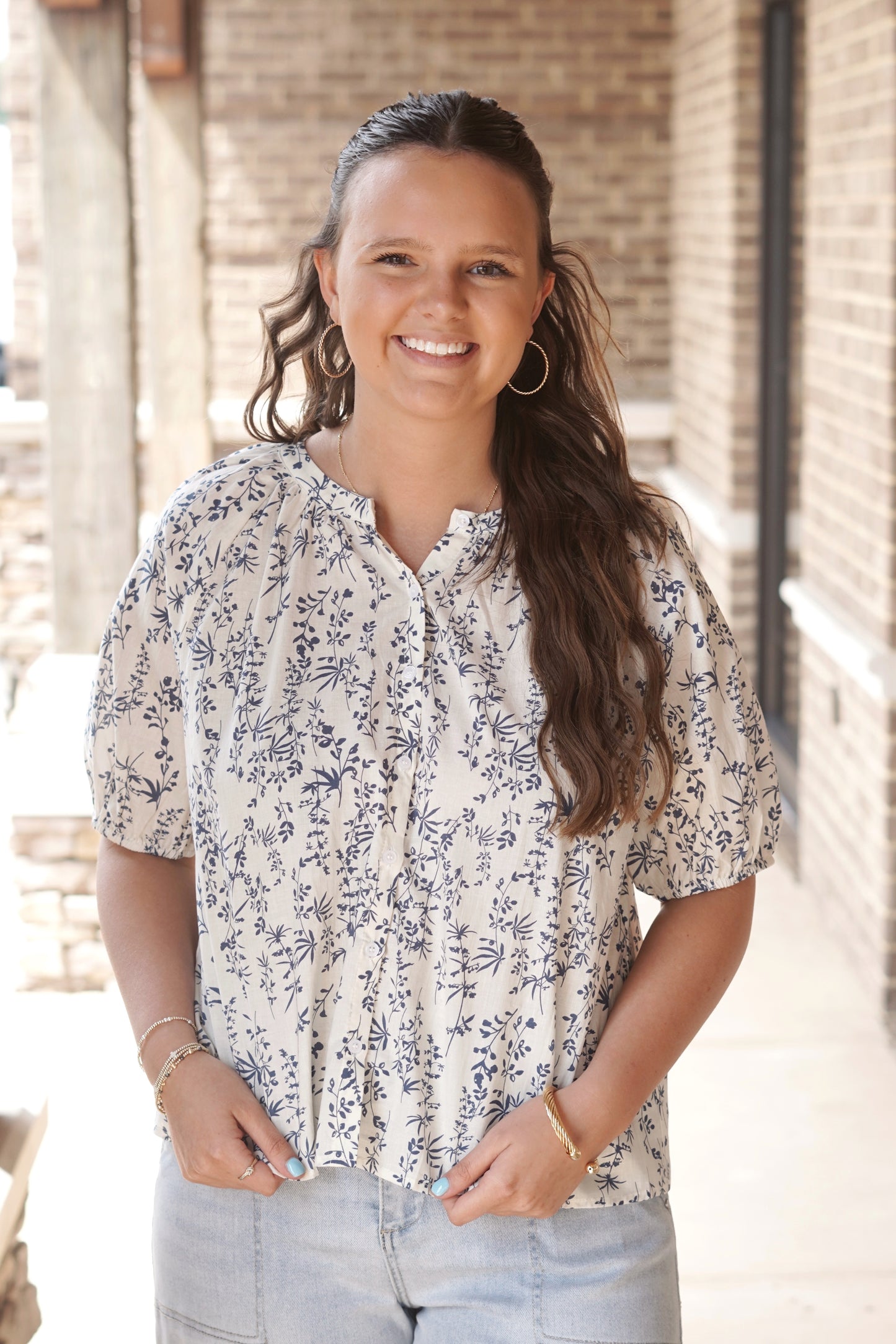 Cream and blue botanical floral printed top. Short sleeves. Round neckline. Button down.