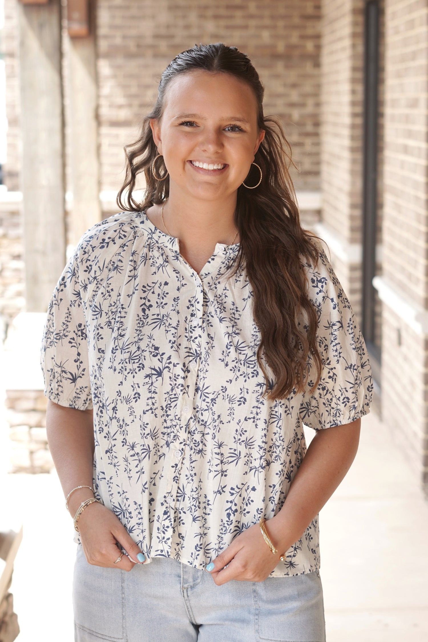 Cream and blue botanical floral printed top. Short sleeves. Round neckline. Button down.