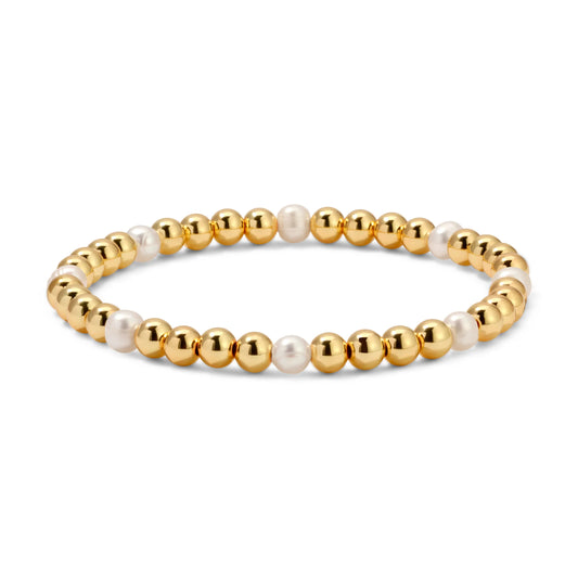 Gold and pearl beaded bracelet on a white background