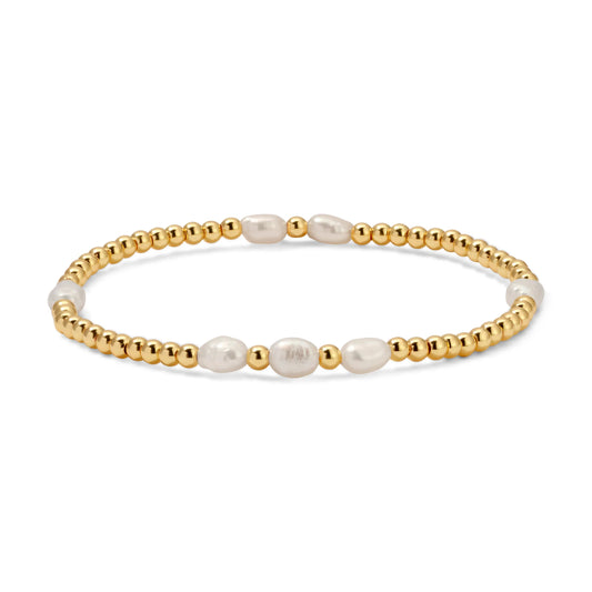 Bracelet with gold beads and pearls on a white background