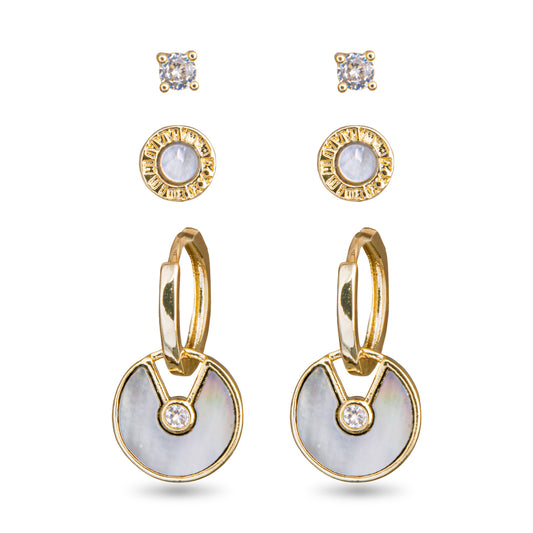 Set of three different pairs of earrings. The first pair has a small circular faux diamond or crystal look. The second pair are circles with gold on the outer part of the circle and mother of pearl in the center. The third pair are gold hoops that have a circular mother of pearl pendant dangling from them with a mother of pearl design and a small faux crystal in the center.