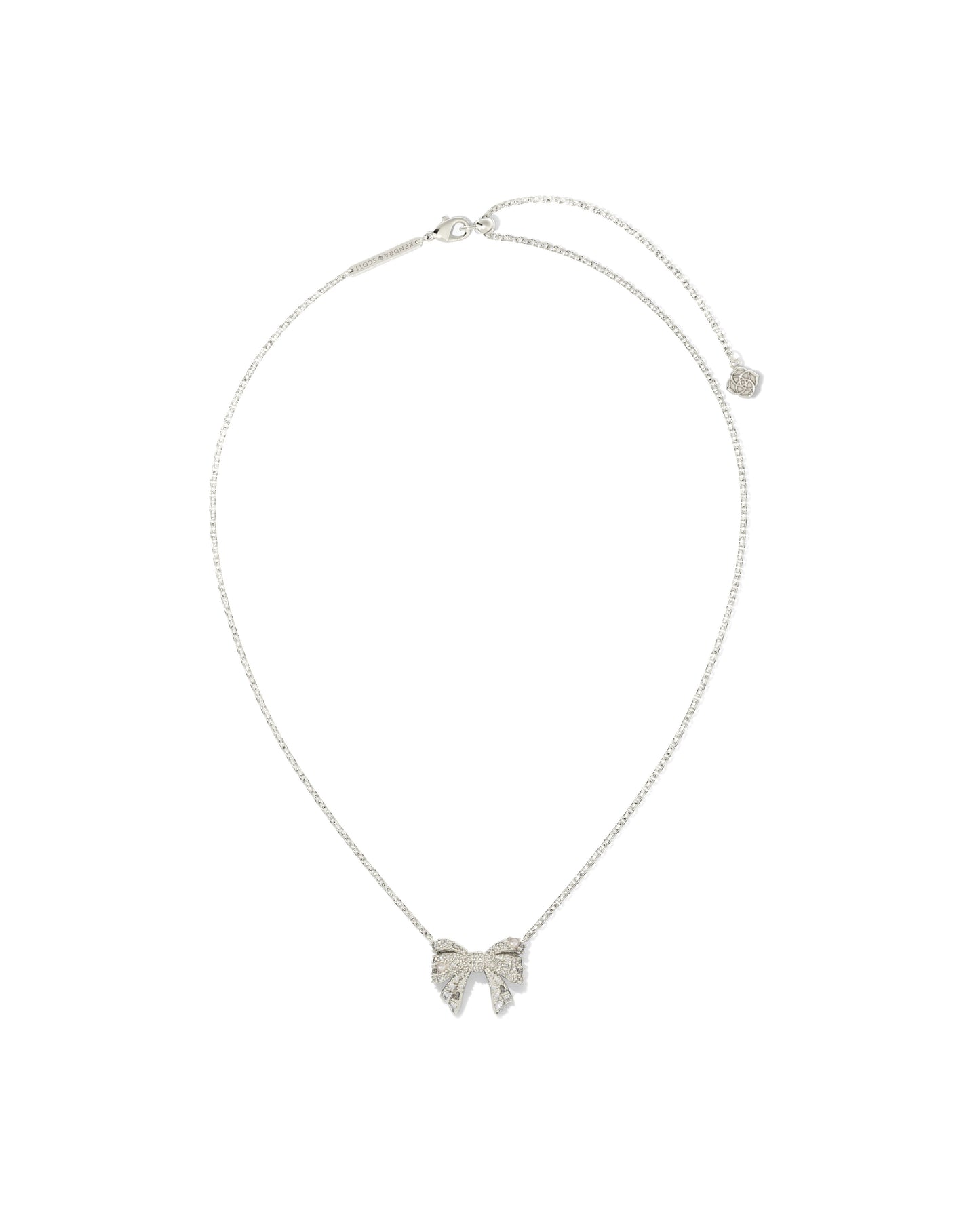 Silver(rhodium) chain necklace with bow pendant. Bow is cover is crystals and small pearls . Lobster clasp with adjustable slider bead.