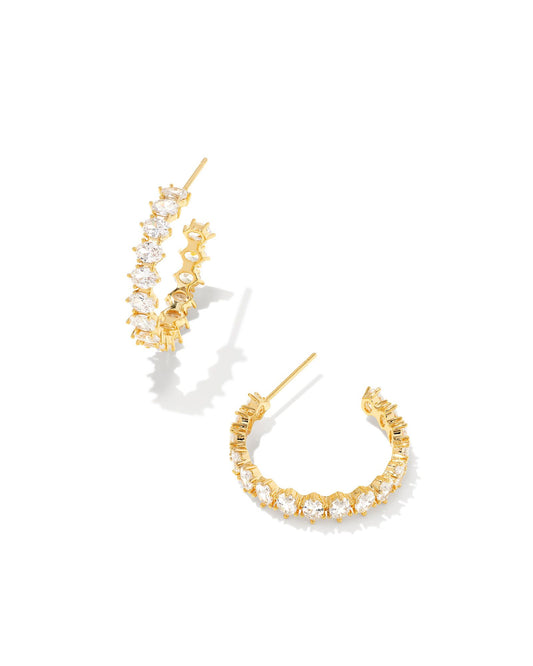  Anchor your ear party with the Cailin Gold Crystal Hoop Earrings in White Crystal. Featuring an elegant single row of crystals, you’ll be the center of attention in these stunning statement hoops.  Dimensions- 1' OUTSIDE DIAMETER Metal- 14k Yellow Gold Over Brass Closure- Ear Post Material-  White Cz