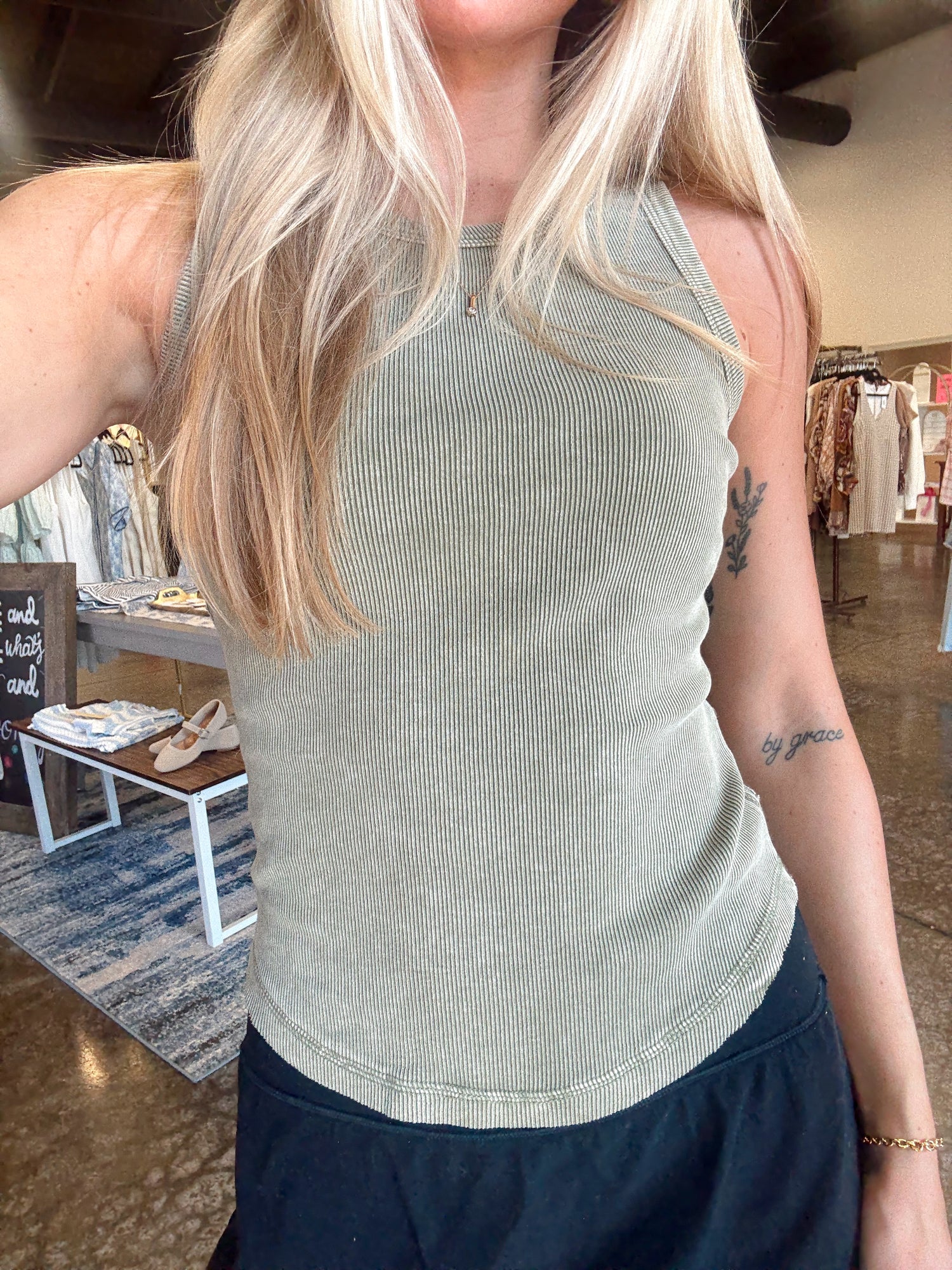 Women wearing a ribbed sage tank, fitted style and a round neckline.  