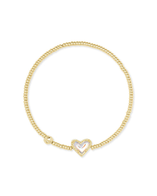 Gold beaded stretch bracelet with a gold ivory mother of pearl heart pendant and one larger bead with a crystal stone