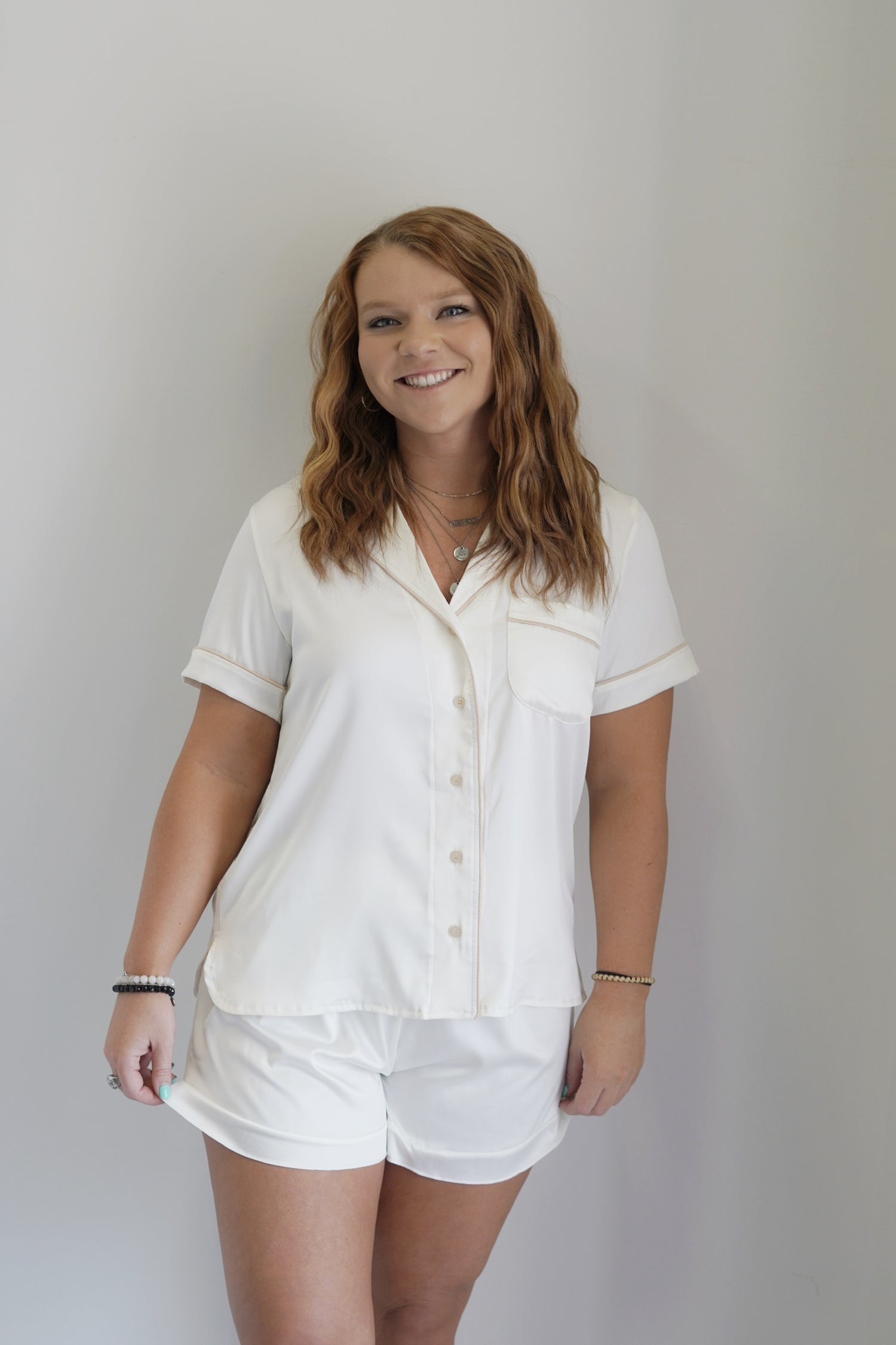 Collared Neckline
Short Sleeves
Button Up
Front Pocket
Relaxed Fit
Colored Trim
Color: Cream
95% Polyester, 5% Spandex