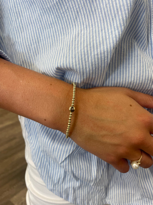Gold beaded bracelet with a evil eye bead