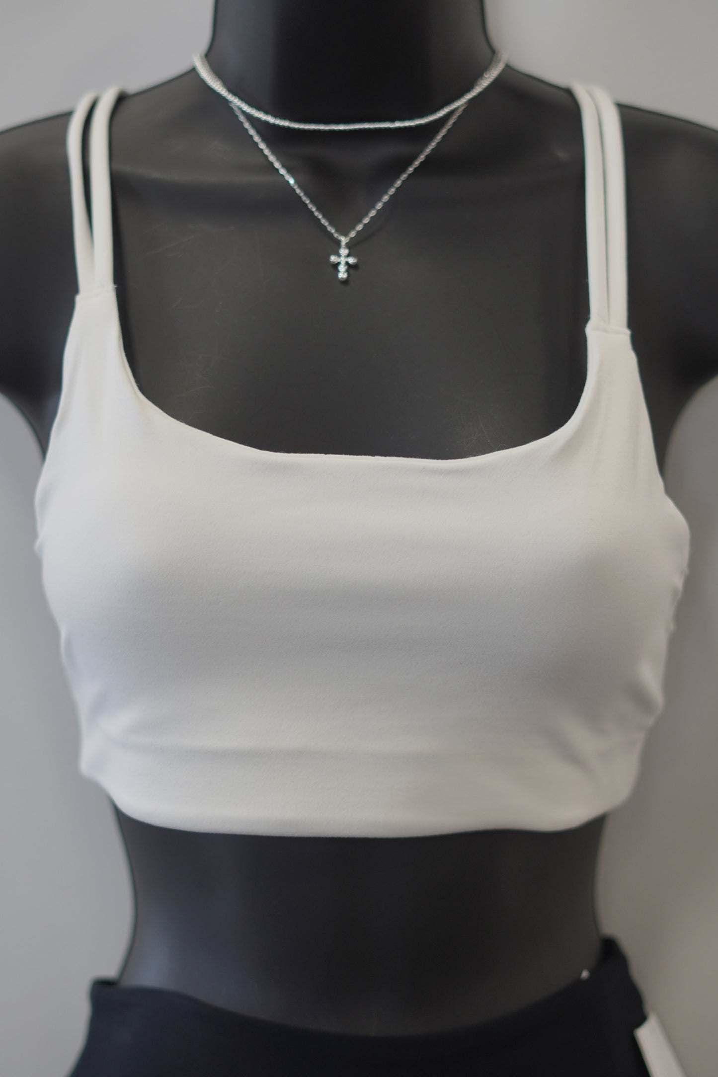 powder color sport bra, scoop neckline, dig-free straps. 