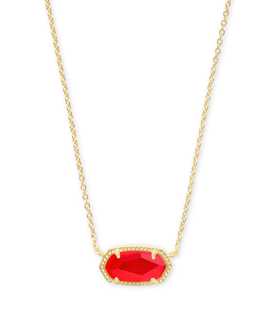 Gold necklace with a small chain and bright red oval pendant