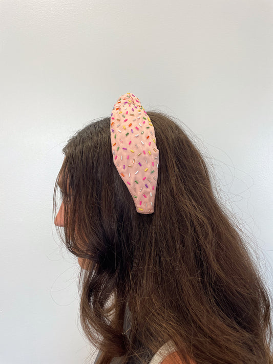 pink faux leather headband studded with multicolored sprinkles