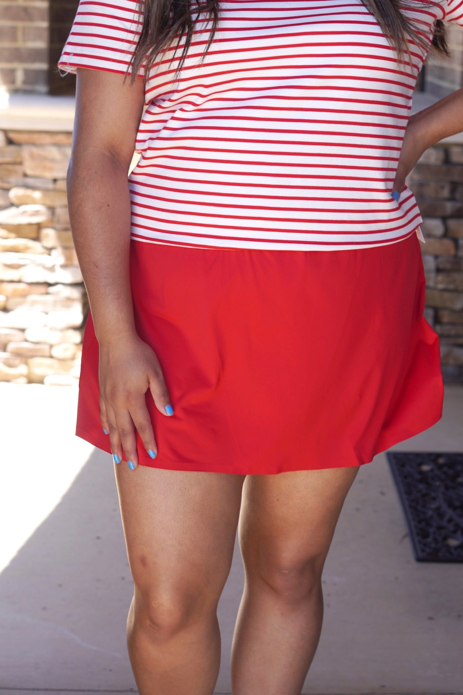 red active skort, flowy fit, elastic waistband, mid-thing length.