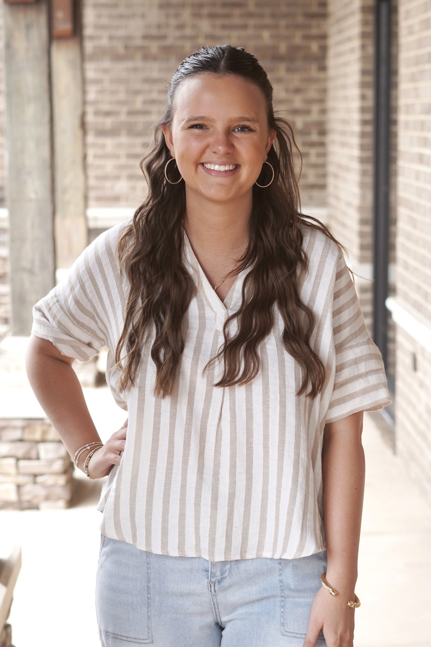 Cream and tan striped top. Stripes are horizontal. V neckline. Short sleeve. Full length top.