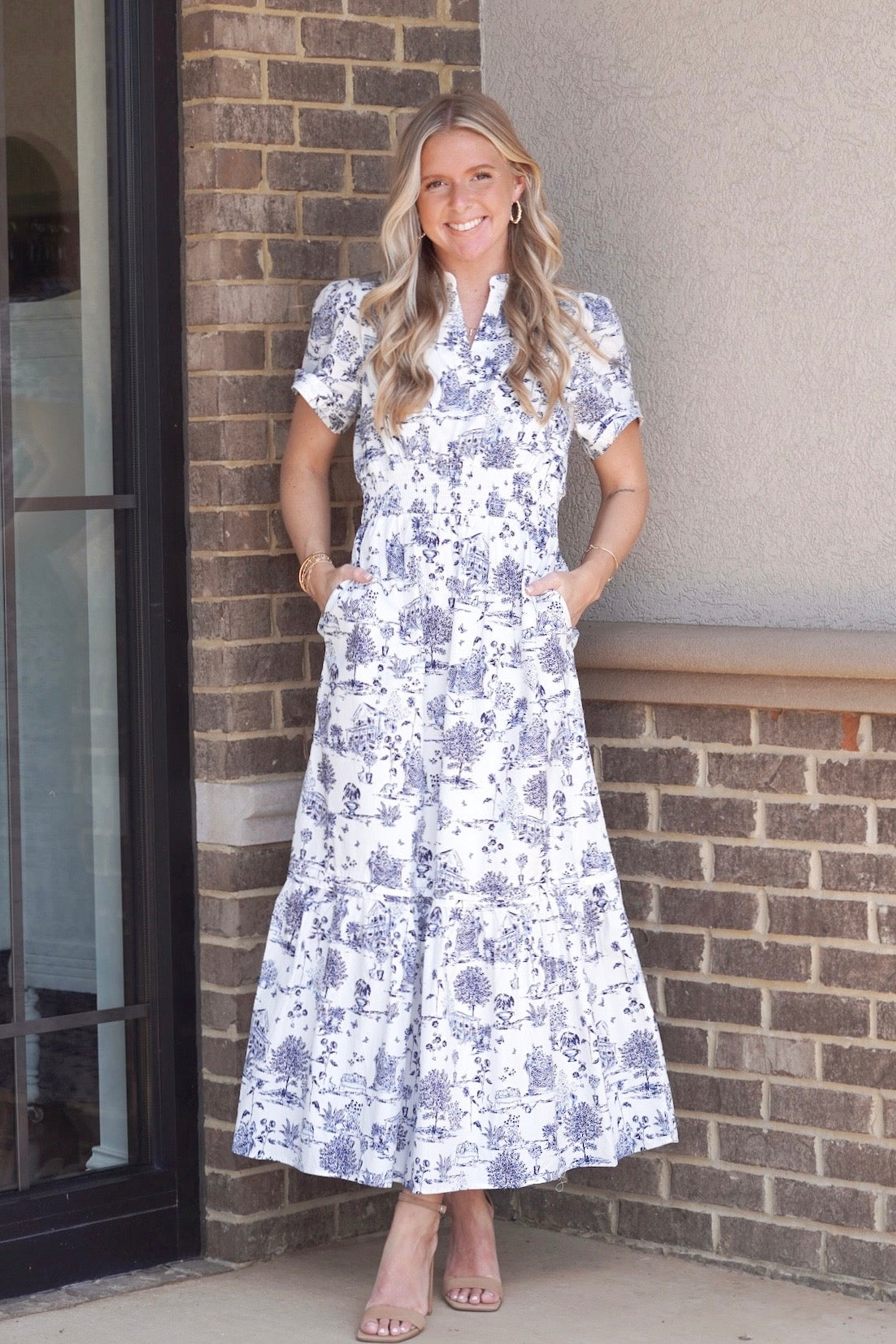 Maxi dress. Blue and white toile print. Cinched waistline. Short sleeves. Long tiered. 