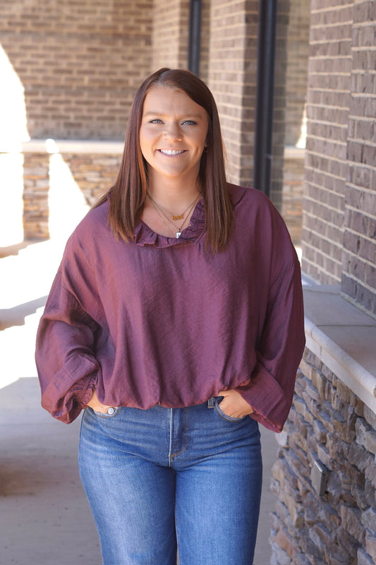 Women wearing g a Plum Flowy Blouse, V-Neckline,
Long Sleeves, Ruffle Detail
Full Length, Elastic Waistline
