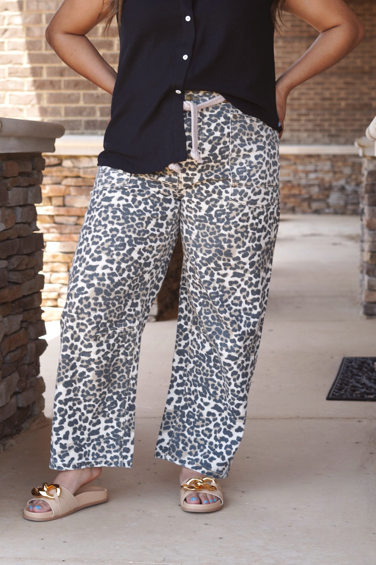 Leopard print wide legged jeans. Belt included with jeans that is rope like material. Front and back pockets. Gold metal hoops serving as belt loops. 