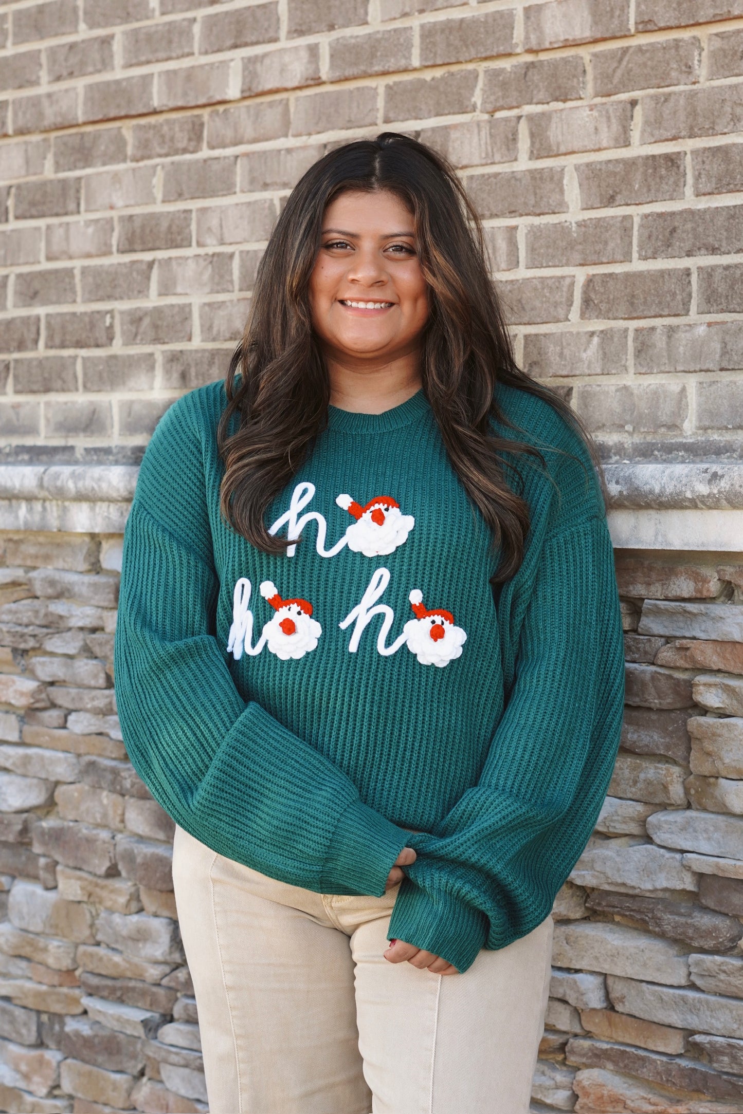 Dark green knit "ho ho ho" sweater with santa faces as the "O" in "ho" 