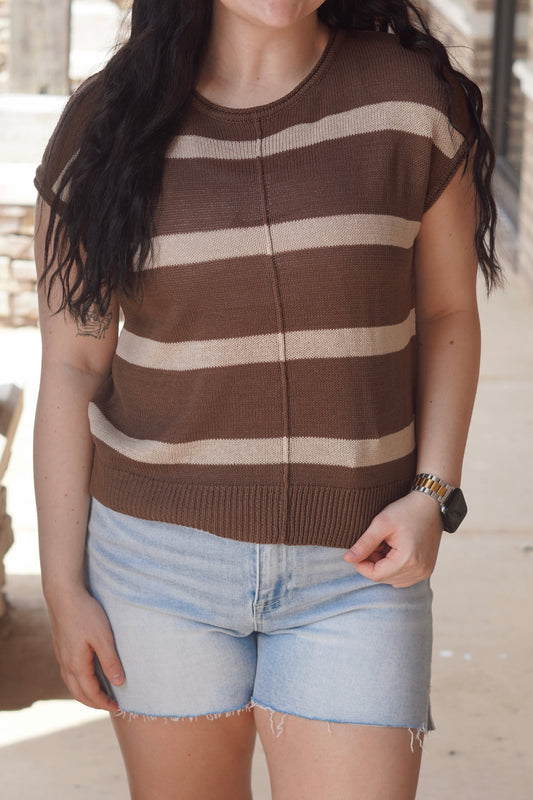 Women wearing brown and mocha striped top with, short sleeve, round neckline, knit material.