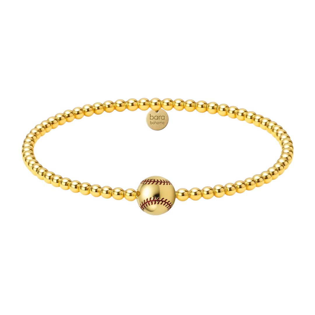 gold beaded bracelet with one large baseball bead