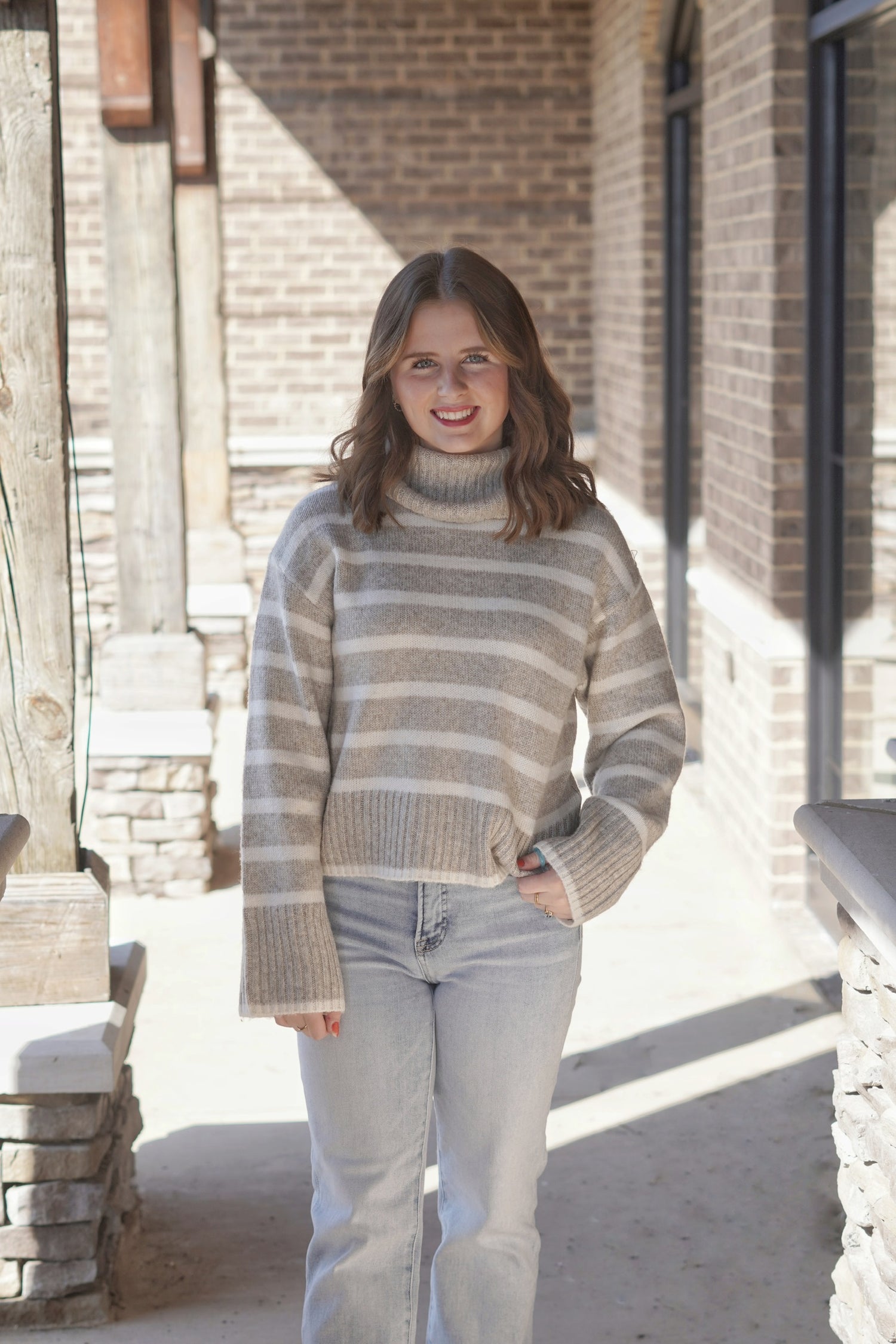 The Josephine Stripe Sweater features a warm, neutral palette perfect for versatile styling. The soft fabric offers a cozy feel, while the classic stripe pattern adds a timeless touch. Pair it with jeans or skirts for a chic, effortless look that's perfect for both casual outings and cozy nights in. 100% Polyester. Heather Taupe