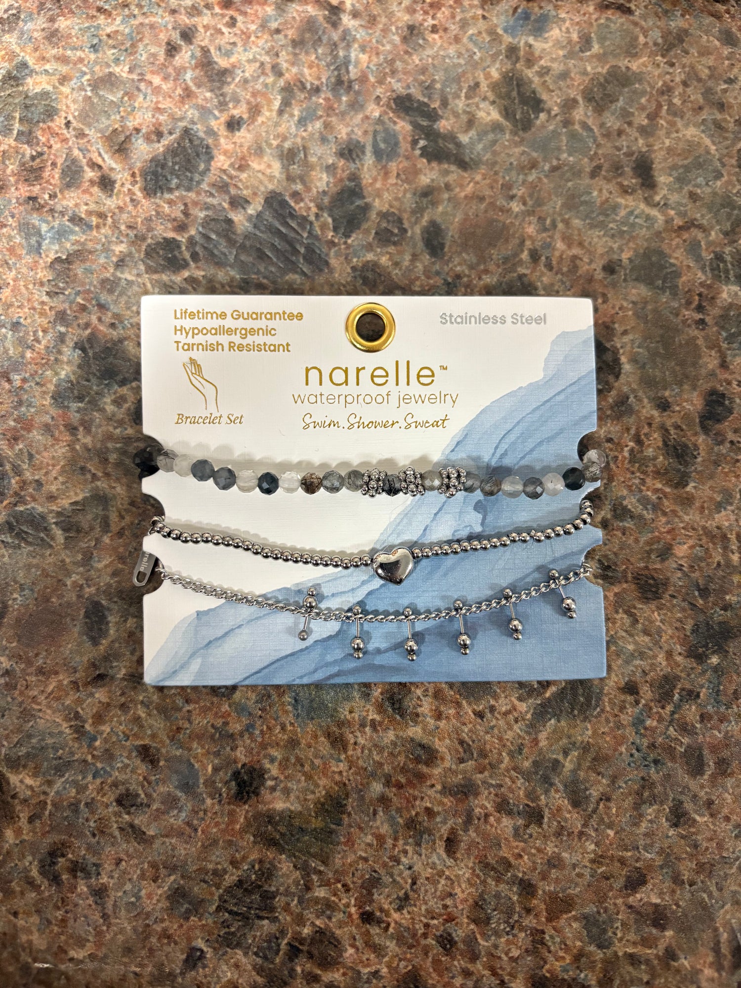 Narelle bracelet set with three silver bracelets with silver charms, black, and grey beads