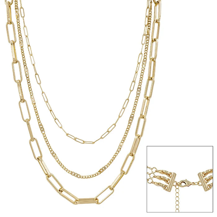 gold three layered Necklace, each layered chain being a different style. 