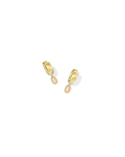 Gold huggie hoop earrings with pink stone on a gold frame. 