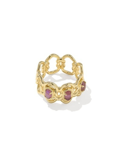Gold ring with pink gemstones and  braided metal detailing.