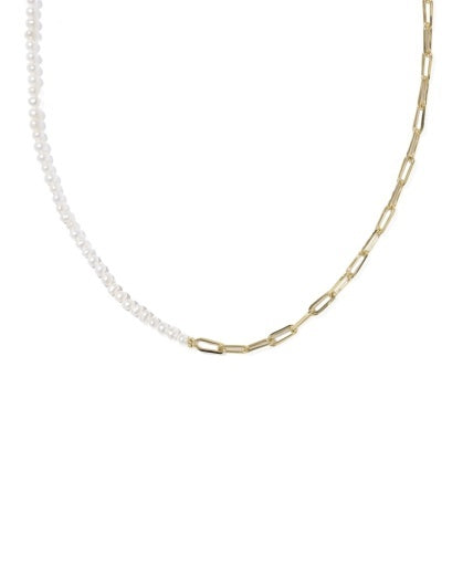Gold chain necklace split in half with a white beaded extension on a white background
