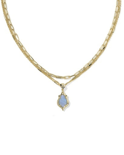 Gold necklace with a blue pendant on a white background