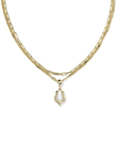 Gold necklace with a teardrop-shaped pendant on a white background