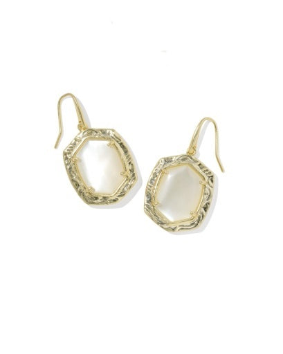 A pair of gold-tone dangle earrings with irregular, organic-shaped cream-colored stone inlays, displayed on a clean white background.