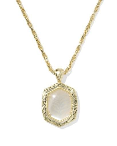 A gold chain necklace with a hexagonal pendant featuring a milky white mother-of-pearl center and an ornate gold border.