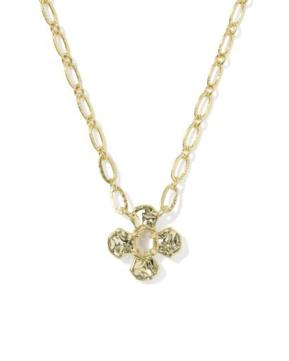 A gold chain necklace featuring a textured, four-petal flower pendant with a clear faceted center stone, shown against a plain white background.